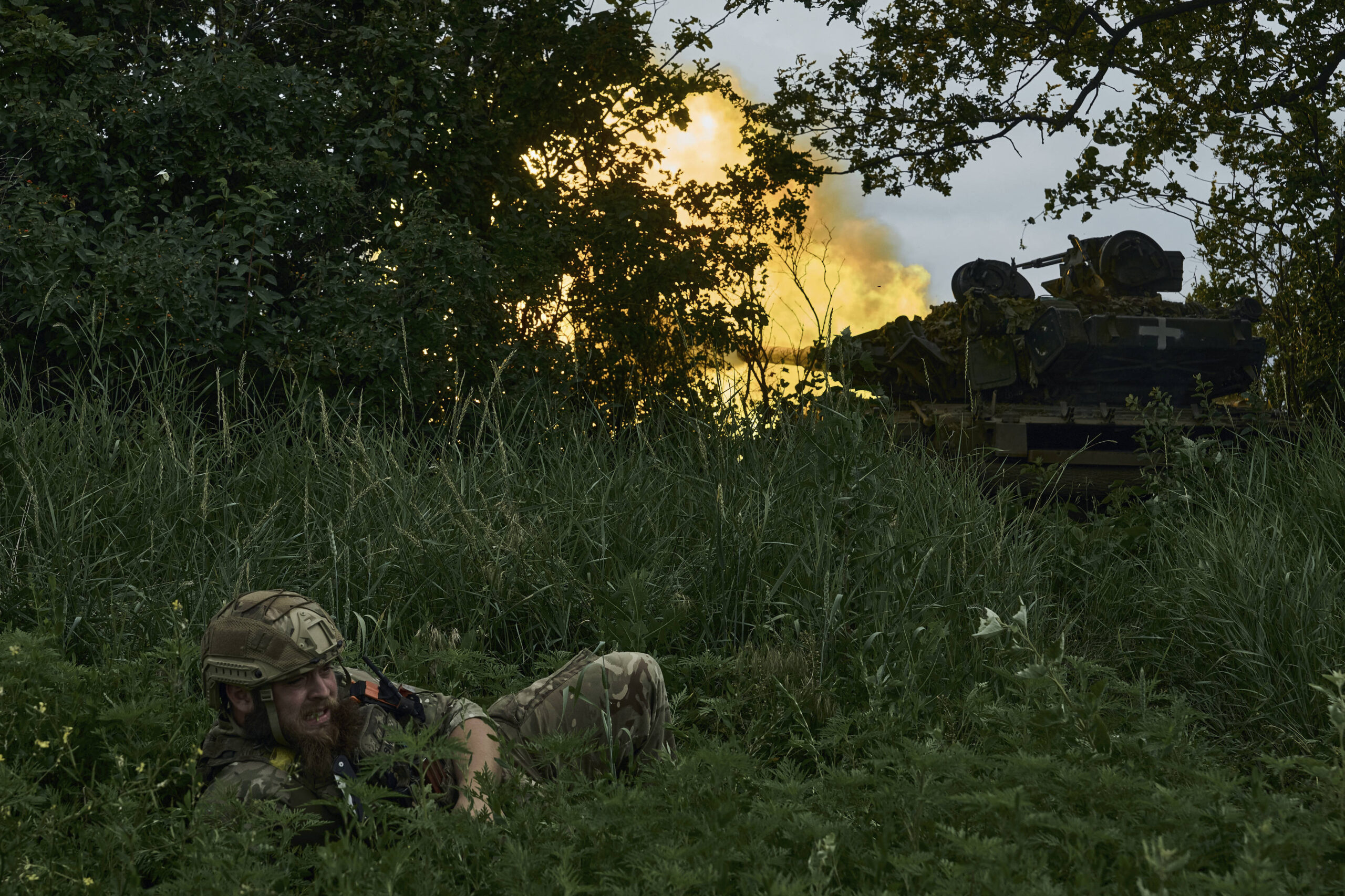 Un soldado ucraniano tendido en el suelo mientras un tanque dispara hacia posiciones rusas en la línea del frente cerca de Bajmut, región de Donetsk, Ucrania, sábado 17 de junio de 2023. Los combates se han intensificado en muchos lugares a lo largo de los 1.500 kilómetros de línea del frente. Las fuerzas ucranianas avanzan con paso firme en los flancos norte y sur de Bajmut, en un semiencerramiento de la ciudad destruida que las fuerzas rusas ocupan desde mayo. © Libkos/AP/SIPA