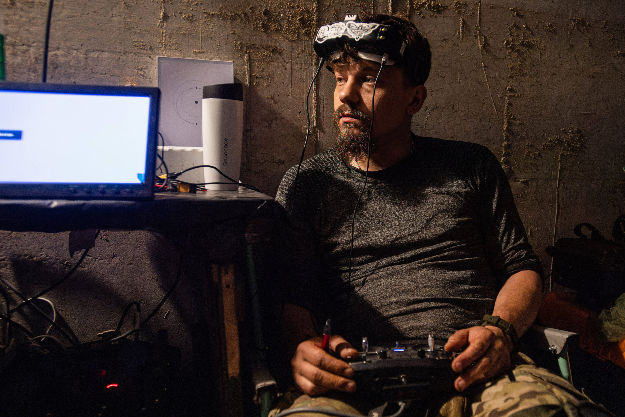 El piloto (nombre en clave «Yoyo») de una unidad ucraniana de drones FPV de la 92.ª brigada, conocida como «Aquiles», pilota un dron dentro de un búnker situado a unos 10 kilómetros de la frontera rusa, en la región de Járkov. Foto de Laurel Chor (SOPA Images).