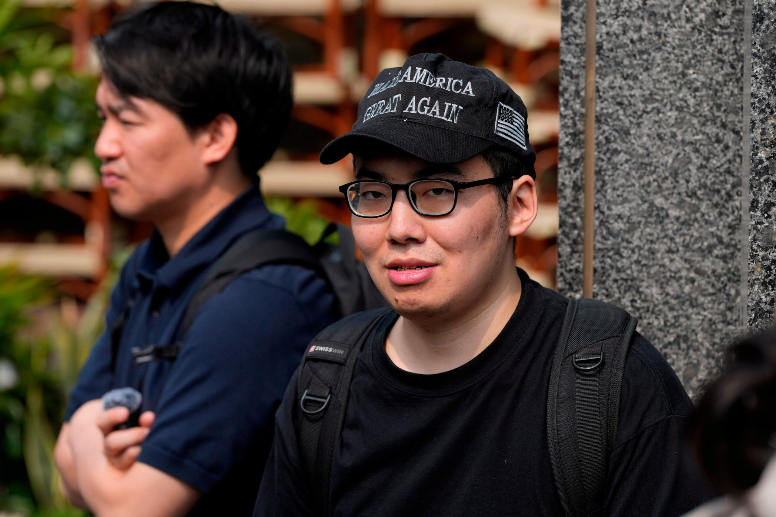 Zhang Lelin, un Américain d'origine chinoise partisan de Trump, porte une casquette sur laquelle est inscrit «Make America Great Again» et déclare à Associated Press espérer apercevoir le président des États-Unis près de son hôtel à Pékin. © Ng Han Guan