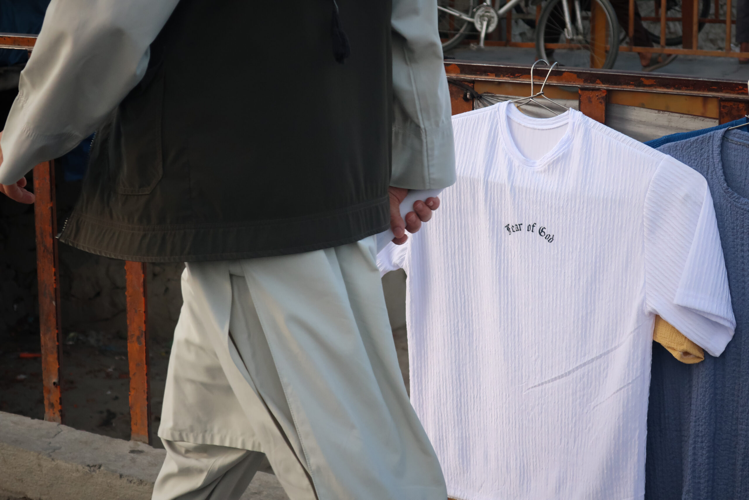 Un’immagine della globalizzazione: contraffazione cinese di un marchio di streetwear di Los Angeles (“Fear of God”), su una bancarella a Kabul. © Nicolò Sancassiani.